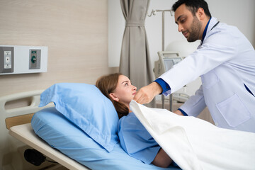 Fototapeta premium The doctor blanketed a patient who had to be hospitalized to take a rest