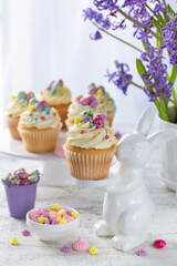 Easter cupcakes decorated with colorful sprinkles end candy eggs