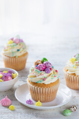 Easter cupcakes decorated with colorful sprinkles end candy eggs