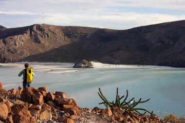 Backpacker hiking next to a beach in Baja California