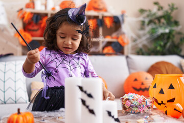 Fototapeta premium Adorable hispanic toddler having halloween party standing at home