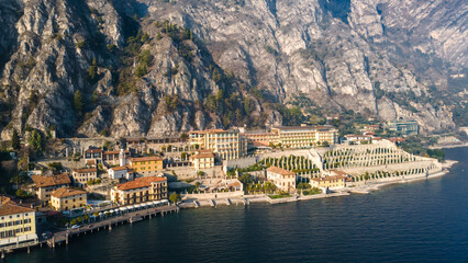 Aerial view of one of the Italian towns on the lake at the foot of the stone mountain