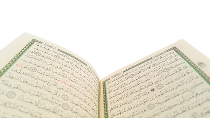 Open Quran pages with white background. Surah Al Baqarah. Arabic letters. Selective focus on...