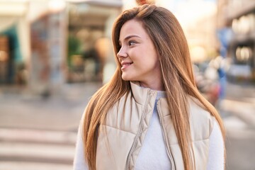 Fototapeta premium Young blonde woman smiling confident standing at street