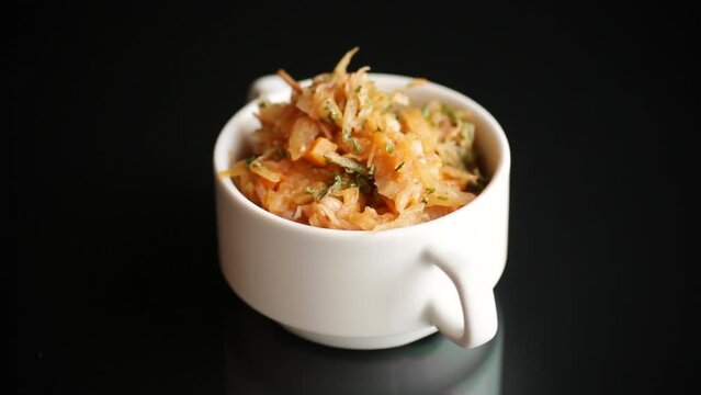 stewed cabbage with carrots and spices in a bowl