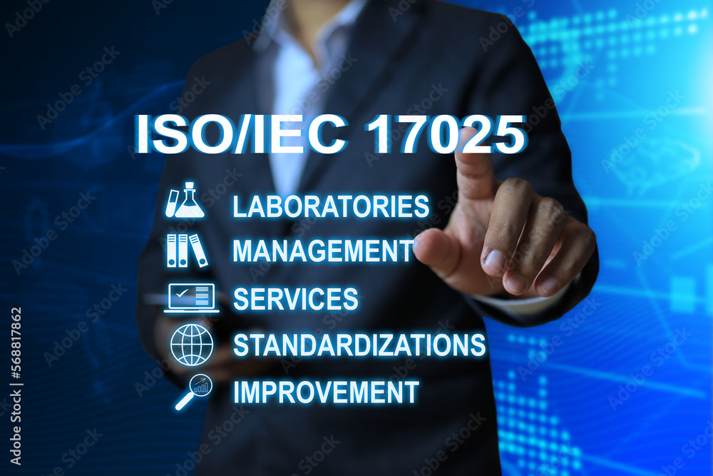 Wall mural Man on a dark blue background is pointing at ISO IEC 17025 wording it's a management standard system for testing and calibration laboratories included the service and improvment guide after audit.