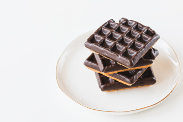 Belgian chocolate waffles from store on plate, white background