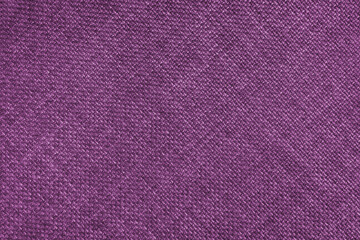 Jacquard woven upholstery, pink coarse fabric texture with diagonal weave lines. Textile background, furniture textile material, wallpaper, backdrop. Cloth structure close up.