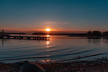 Naklejka premium Sunset on the sea, small pier