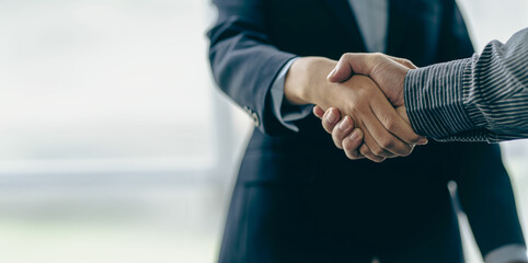 Successful negotiation and handshake concept Two businessmen shake hands with partners to celebrate...