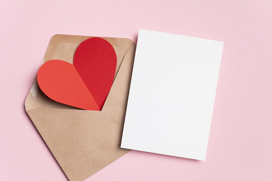 Happy Valentines day card mockup with red heart in envelope on pink