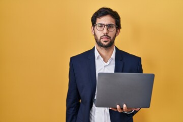 Handsome latin man working using computer laptop looking sleepy and tired, exhausted for fatigue...