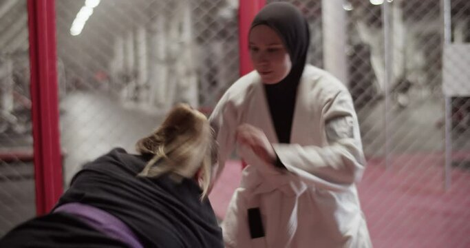 Female fighter trying to grab Muslim opponent