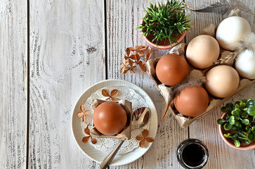 Composition with Easter eggs and branches on wite background.Postcard.