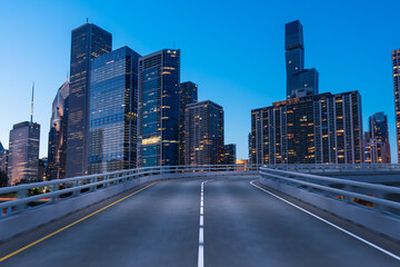 Fototapeta na wymiar Empty urban asphalt road exterior with city buildings background. New modern highway concrete construction. Concept of way to success. Transportation logistic industry fast delivery. Chicago. USA.