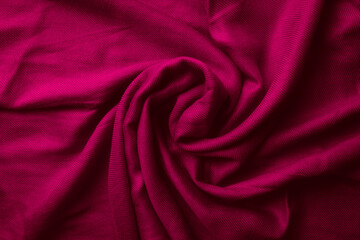 Fabric texture background of magenta color (Viva Magenta). Close up of clothes as wallpaper.