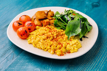 fried scrambled eggs with meat and paprika