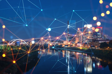 Panoramic view of Broadway district of Nashville over Cumberland River at illuminated night skyline, Tennessee, USA. Social media icons. The concept of networking and establishing people connections