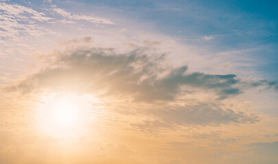 Sunset sky clouds in the evening with orange sunlight on golden hour 
