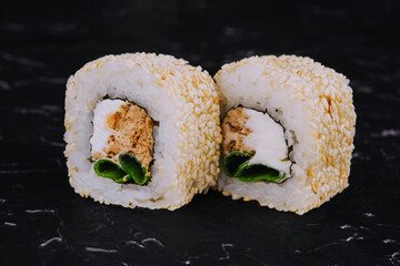 sushi roll with sesame seeds with tuna fillet inside roll
