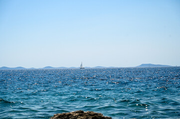 A ship on the sea. Sea waves in summer. Sea coast. Sailing on the blue sea. 