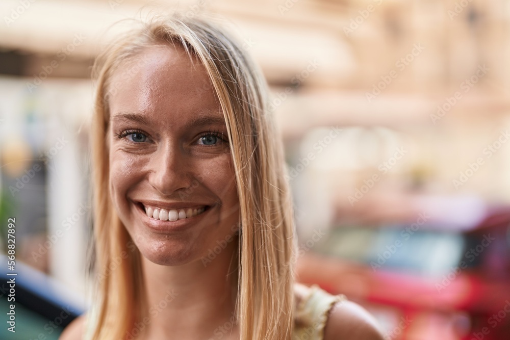 Sticker young blonde woman smiling confident standing at street