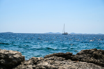 A ship on the sea. Sea waves in summer. Sea coast. Sailing on the blue sea. 