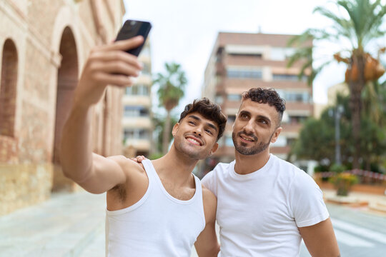 Two hispanic men couple smiling confident make selfie by smartphone at street