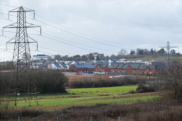 Urban sprawl in the form of a new housing estate encroaching on farmland near Exeter. Development of such rural sites has become a controversial issue in the UK
