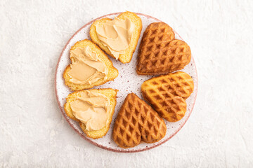 Homemade waffle with peanut butter on a gray concrete. top view, flat lay, close up.