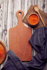 Wooden cutting board mock up, copy space. Raw no cooking lentil. Healthy superfood on the natural background. Aesthetics healthy vegan product