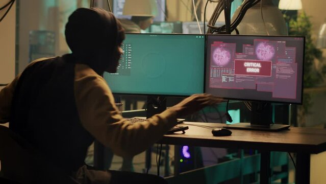 Team of hackers celebrating web espionage success on multiple monitors, feeling happy about skilled cybercrime attack. Thief doing illegal activity with malware and virus, clap hands. Handheld shot.