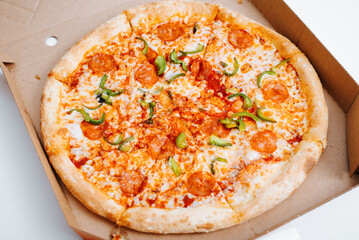 Fresh classic pizza in a cardboard box, food delivery