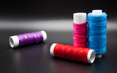 colored threads on a dark background