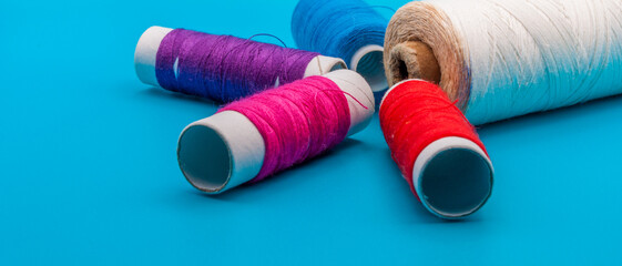 colored threads on a blue background