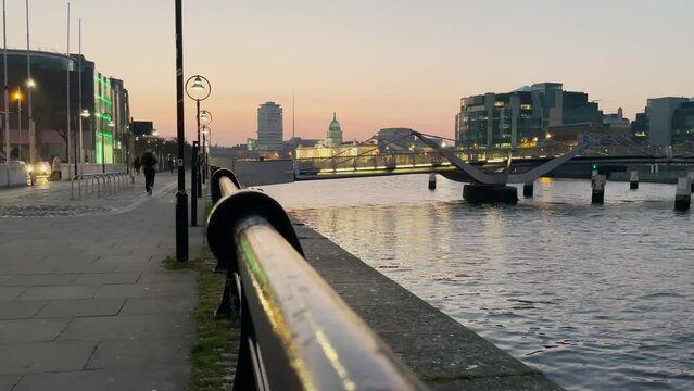 Custom House quay, Dublin Sean o'Casey bridge action at dusk, liffey river, view from the quays, horizontal.