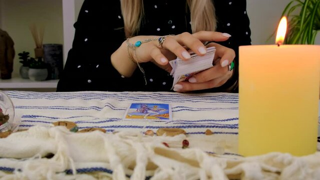 Fortune teller woman reads tarot cards. Selective focus.