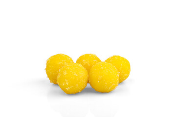 Yellow dragee with sugar isolated on white background.