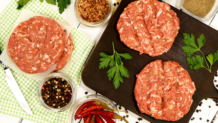 Round fresh raw mince beef burger cutlet ready to prepare on dark kitchen board. - 568838444