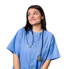 Young nurse woman isolated dreaming of achieving goals and purposes