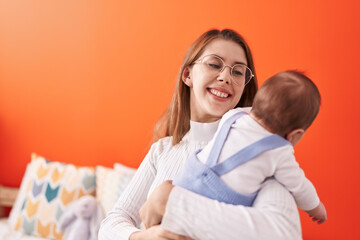 Fototapeta premium Mother and son hugging each other standing at home