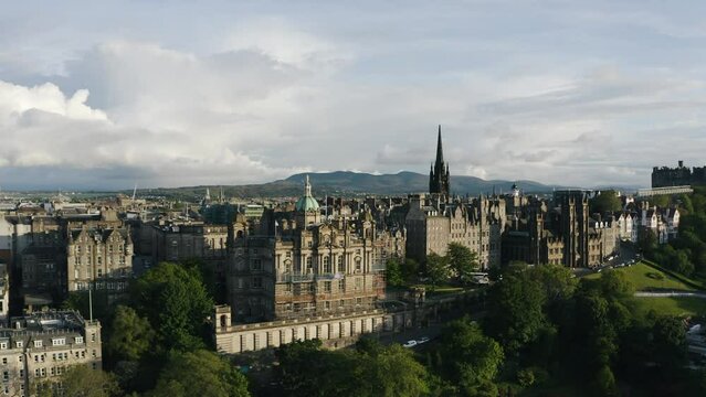 Aerial view of Edinburgh's Museum on the Mound with sunlight casting warm light on the downtown buildings.
