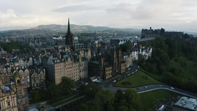Aerial view of Edinburgh's downtown area with numerous chapels, bars, and historic landmarks on the horizon.