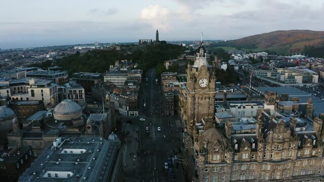 Orbiting aerial shot of an old clock tower in Scotland's capital city of Edinburgh.