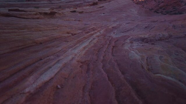 Gimbal booming up and rolling focus shot of the sandstone Fire Wave in Valley of Fire, Nevada. 4K