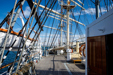 Wooden deck of an old sail ship, sailboat rigging.