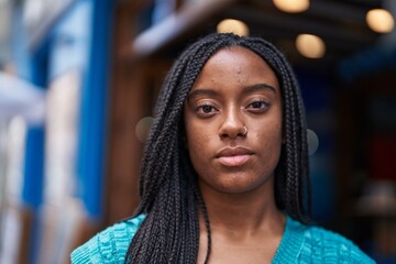 African american woman standing with relaxed expression at street