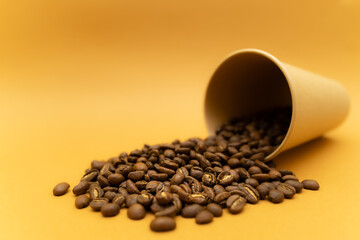 scattered coffee beans on the background of a glass