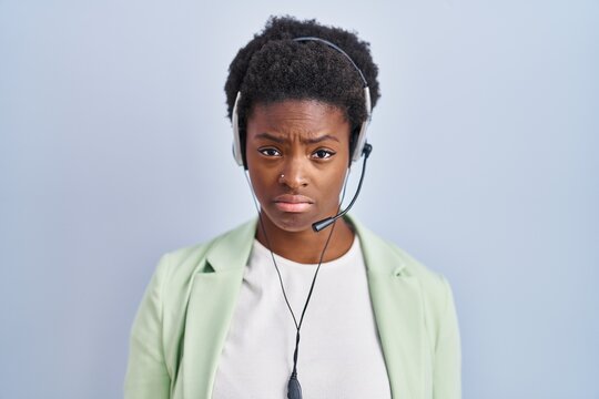 African american woman wearing call center agent headset depressed and worry for distress, crying angry and afraid. sad expression.