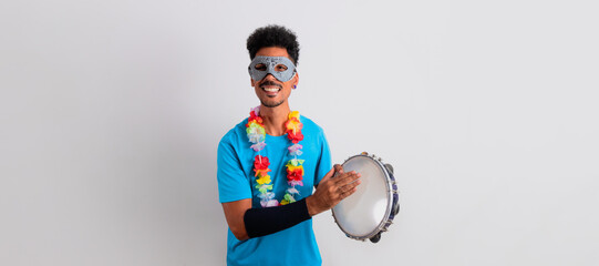 Black Man With Carnival Costume Holding a Tambourine Isolated on White.